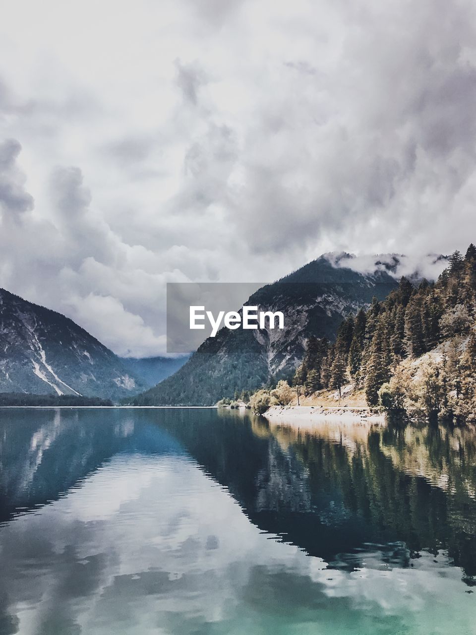 Scenic view of lake and mountains against sky