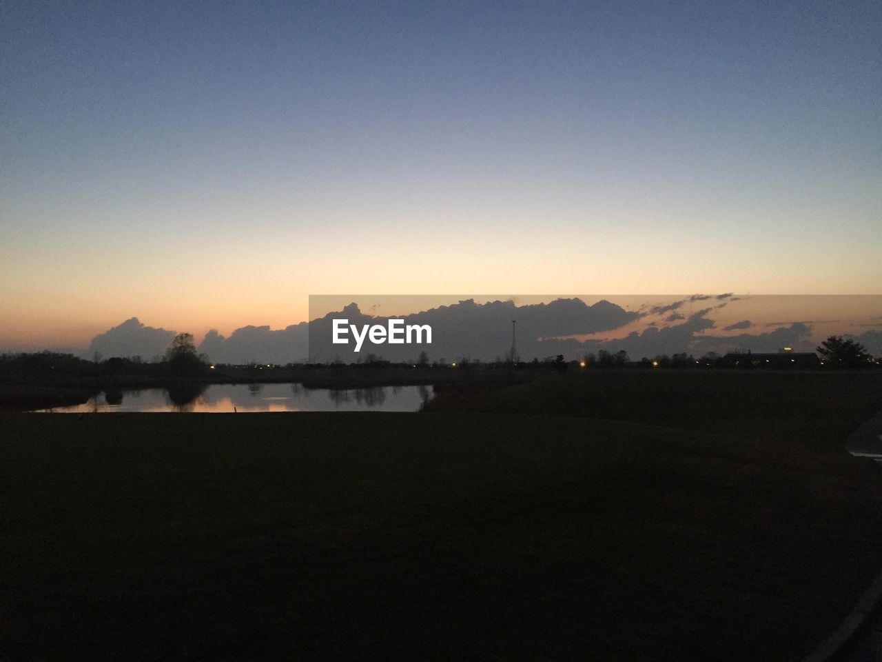 SCENIC VIEW OF RIVER AT SUNSET