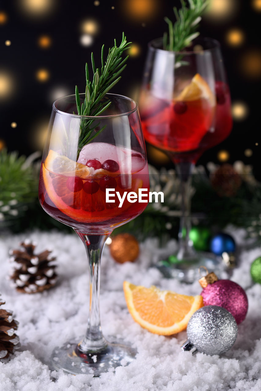 Cocktail margarita with cranberries, orange and rosemary. a perfect cocktail for a christmas party