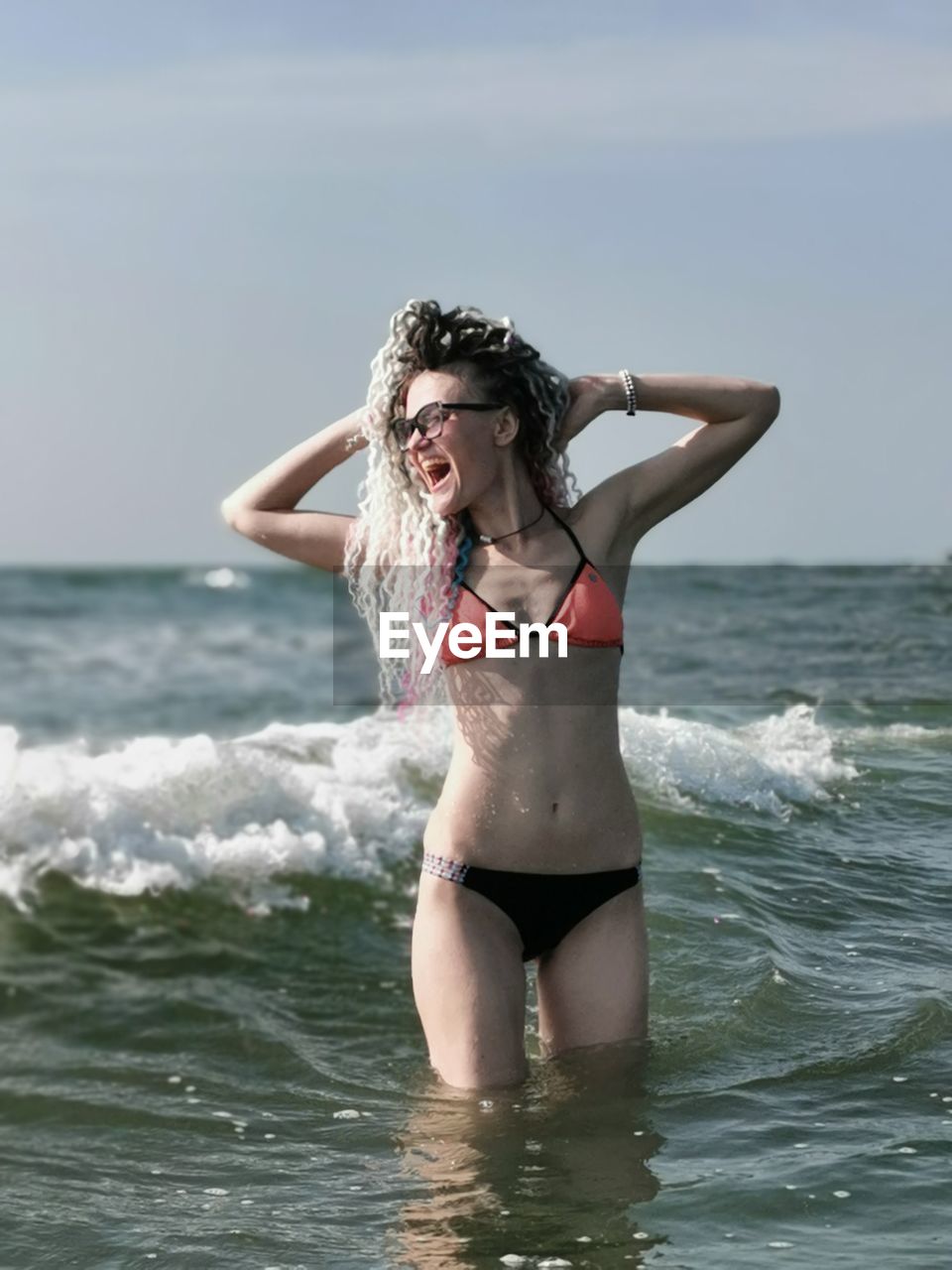 Young woman in bikini standing at beach