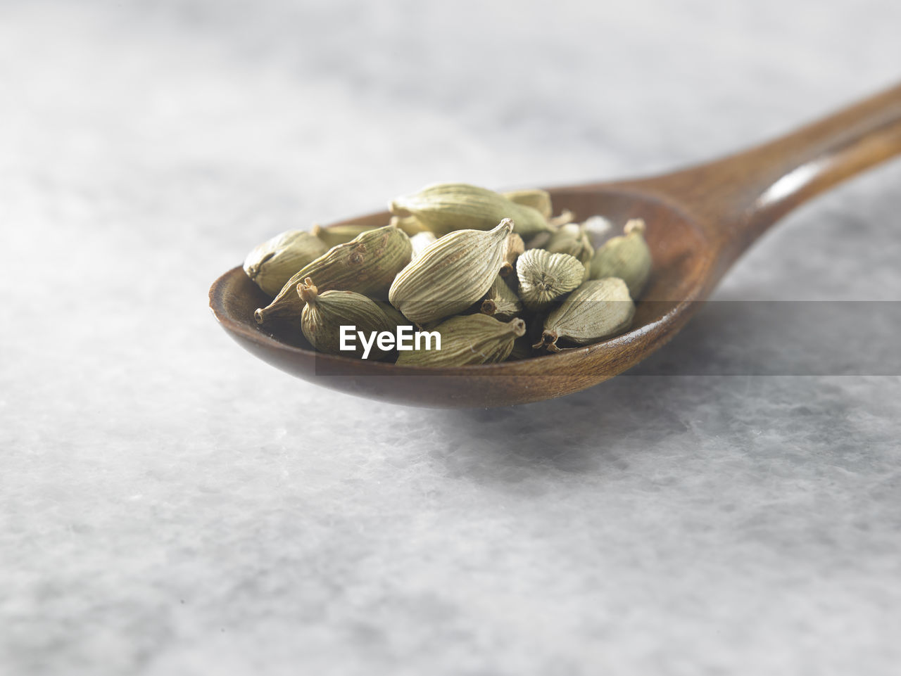 Close-up of cardamoms in spoon