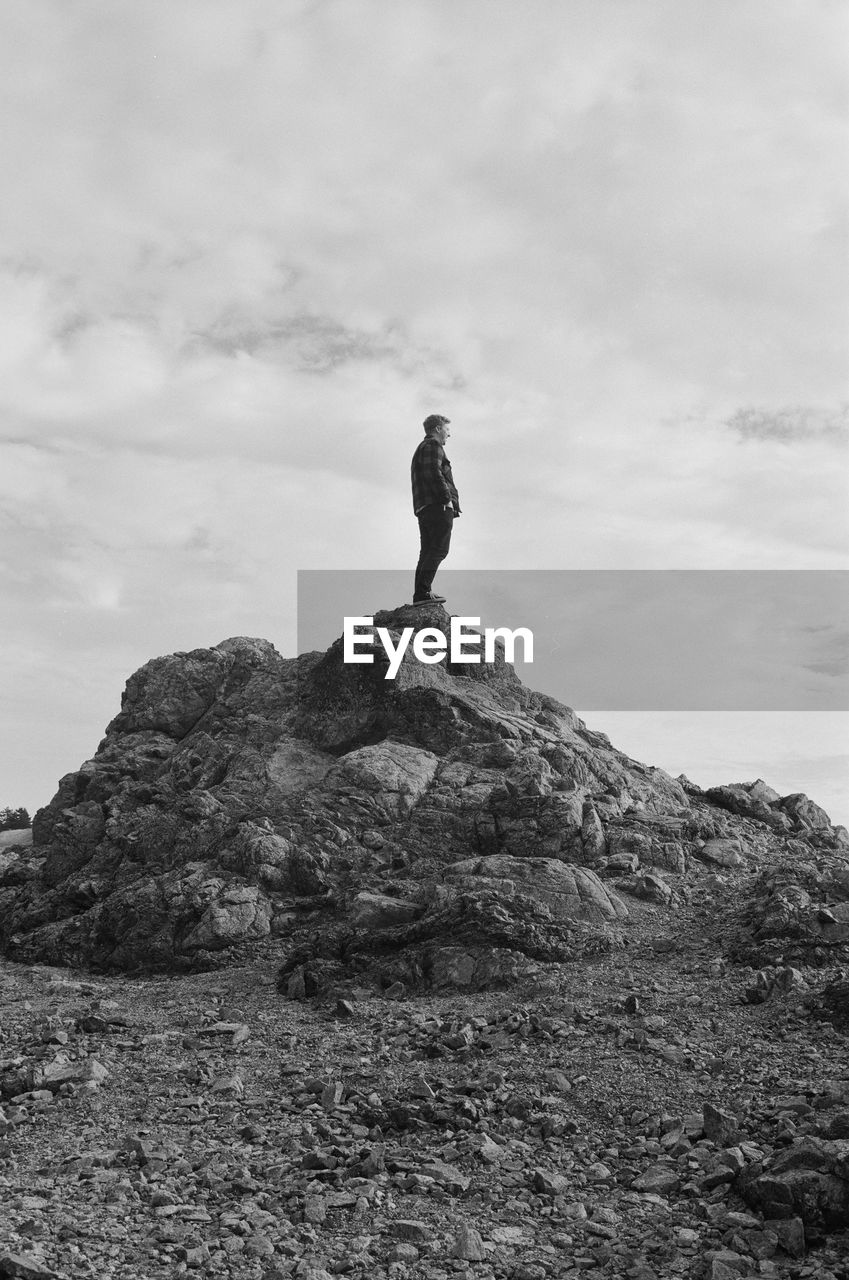 SILHOUETTE OF MAN STANDING ON LANDSCAPE