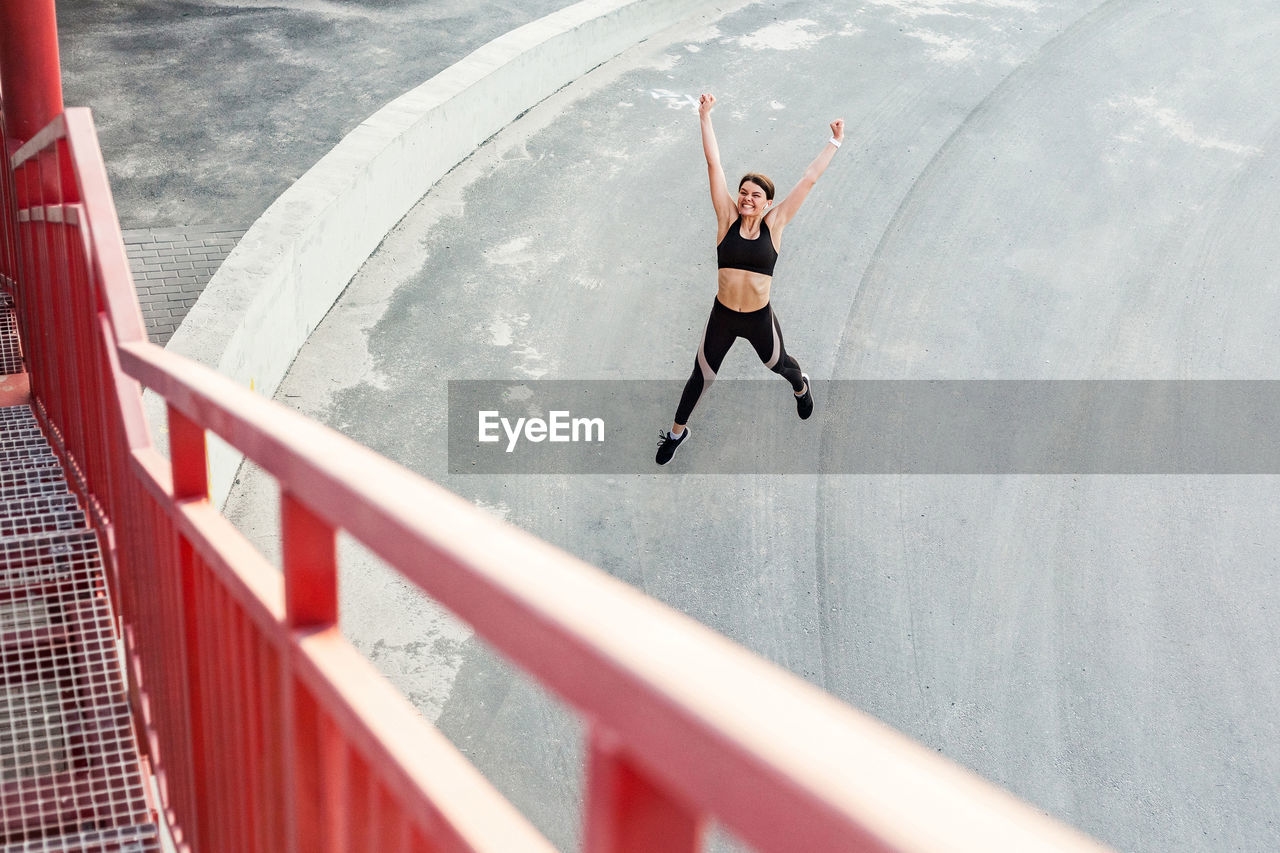 High angle view of woman jumping outdoors