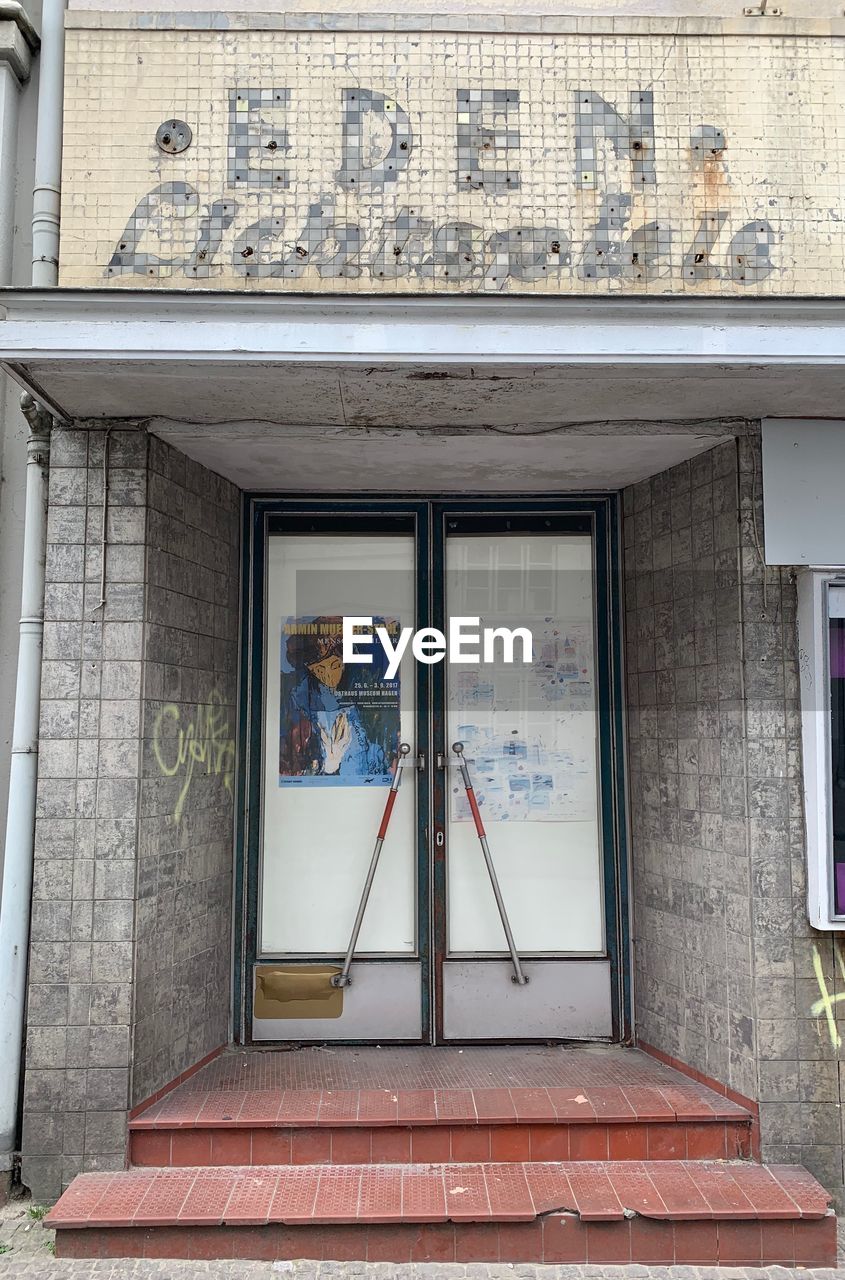 REFLECTION OF BUILDING ON GLASS WINDOW WITH DOOR