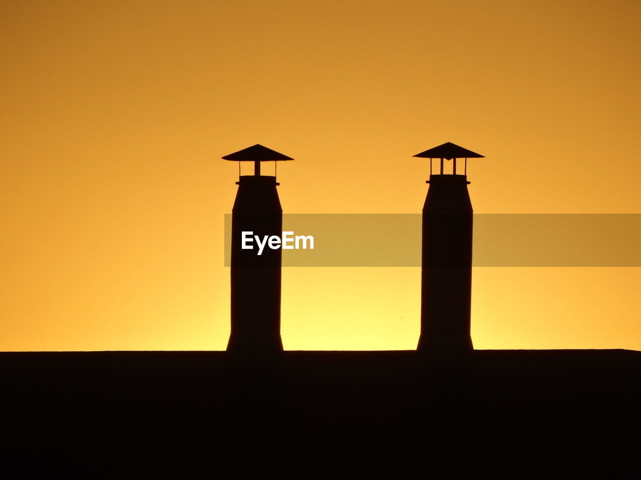 SILHOUETTE OF A BIRD AGAINST SKY DURING SUNSET