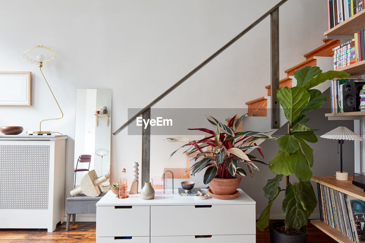 Staircase in loft apartment with bookshelves, storage cabinet