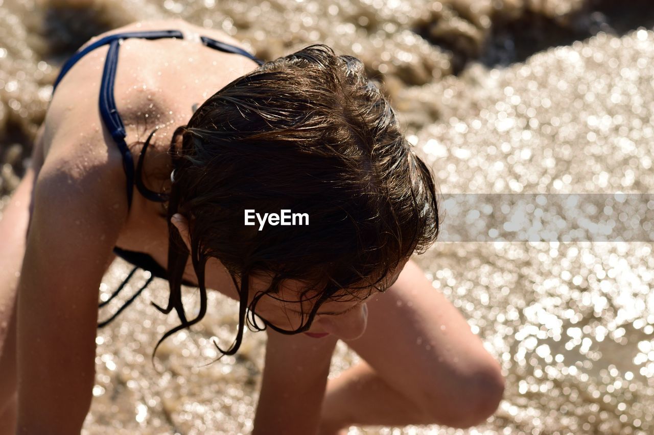 Full length of shirtless girl on beach