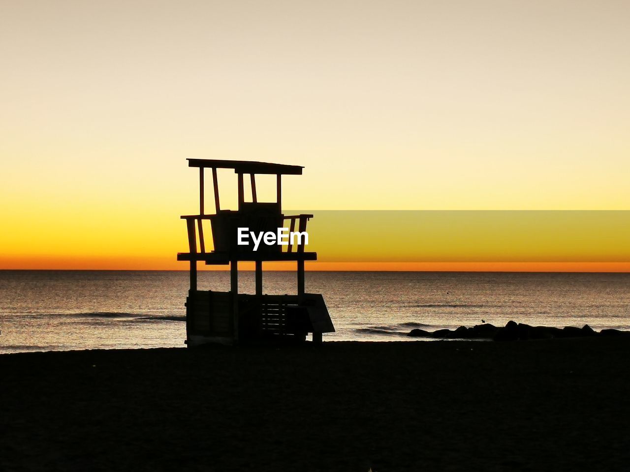 LIFEGUARD HUT ON BEACH DURING SUNSET