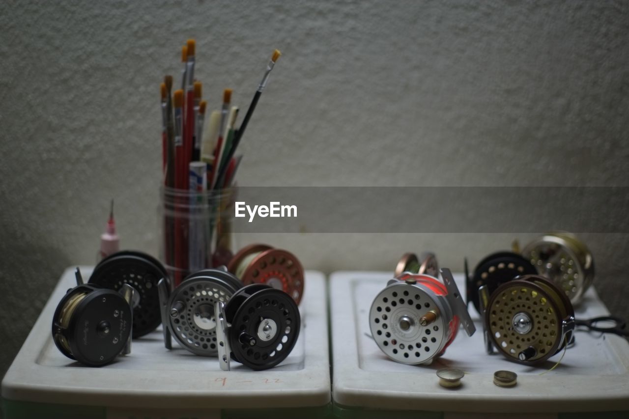 Close-up of spools and brushes on table