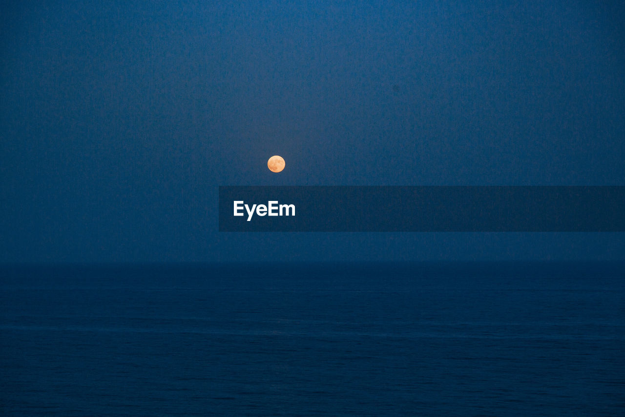 SCENIC VIEW OF SEA AGAINST MOON IN SKY