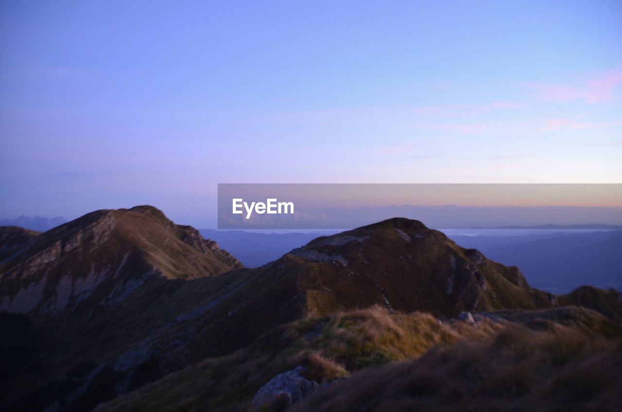 Scenic view of mountains against sky during sunset