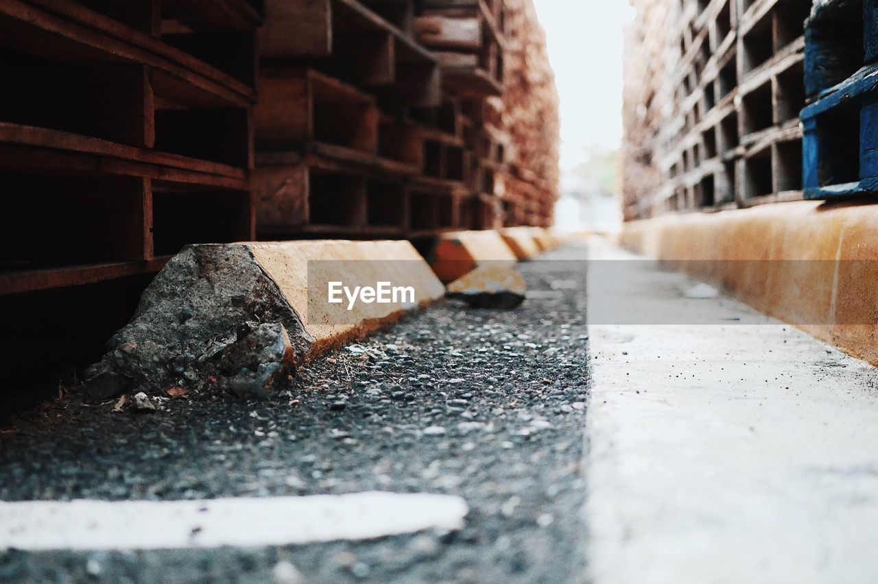 Stacked wooden pallets on footpath