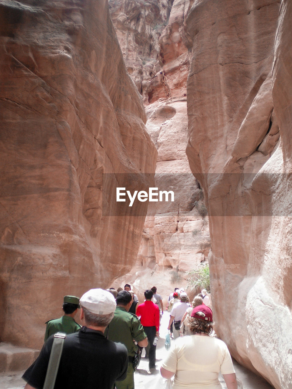 rock, rock formation, group of people, travel destinations, travel, adult, men, nature, geology, tourism, women, canyon, physical geography, leisure activity, wadi, architecture, rear view, tourist, arch, history, day, lifestyles, activity, beauty in nature, the past, mountain, outdoors, adventure, non-urban scene, exploration, ancient, medium group of people, clothing, religion, scenics - nature, holiday, vacation, trip, cliff, crowd, formation, group