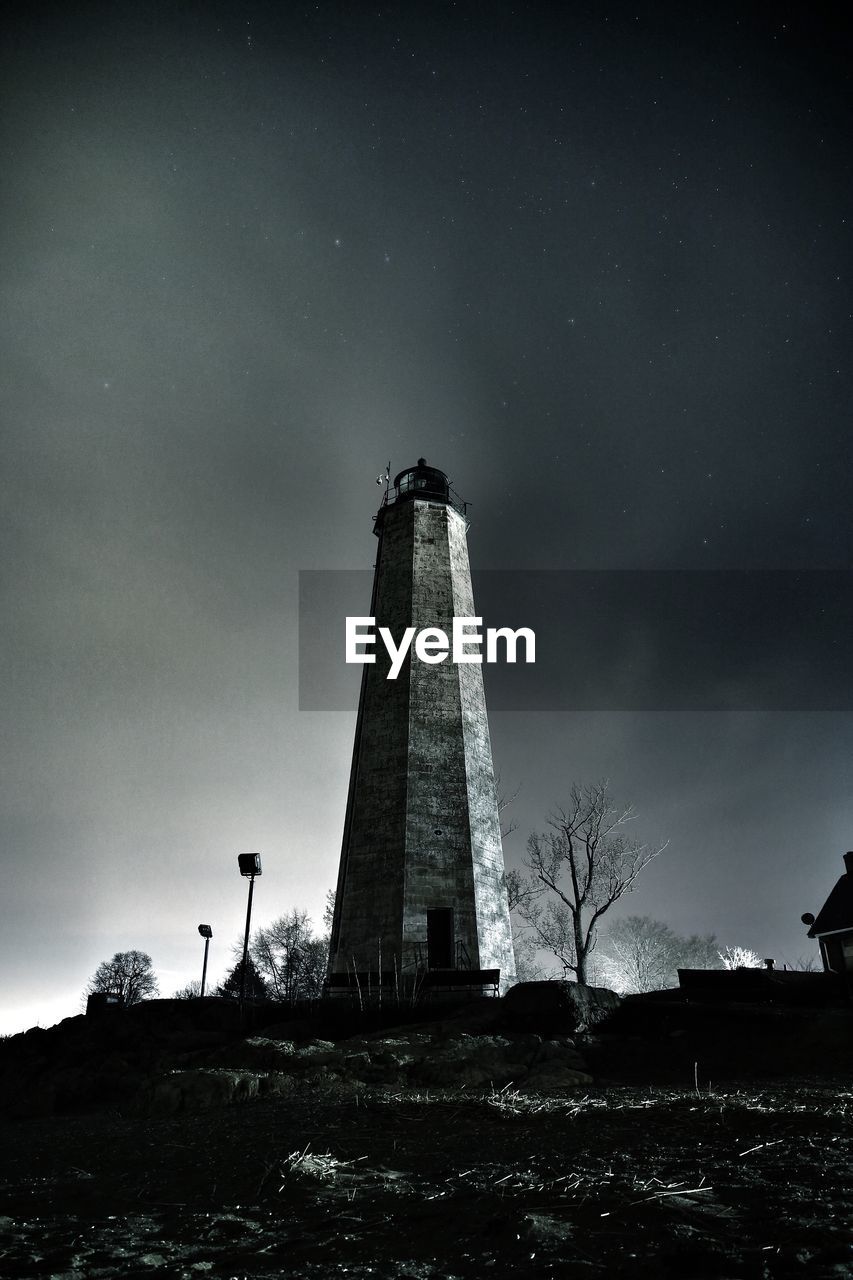 Lighthouse against sky at night