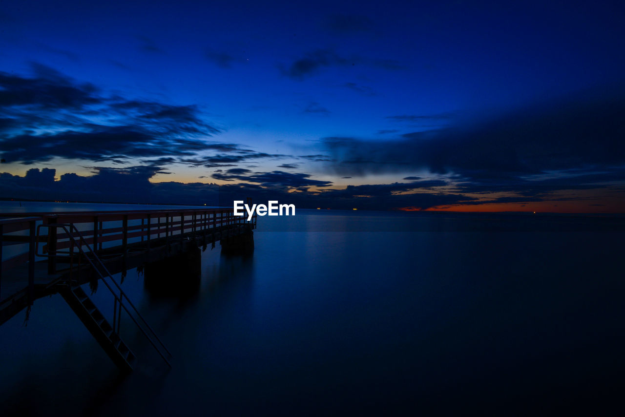 Scenic view of sea against sky at sunset