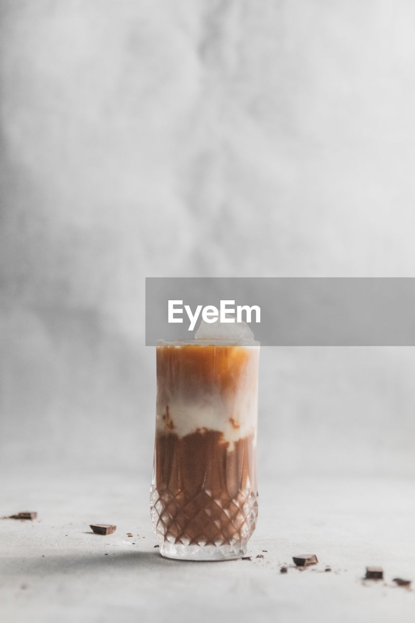 Close-up of iced coffee with chocolate layers on table