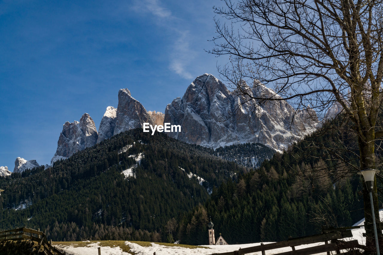 Low angle view of mountains against blue sky