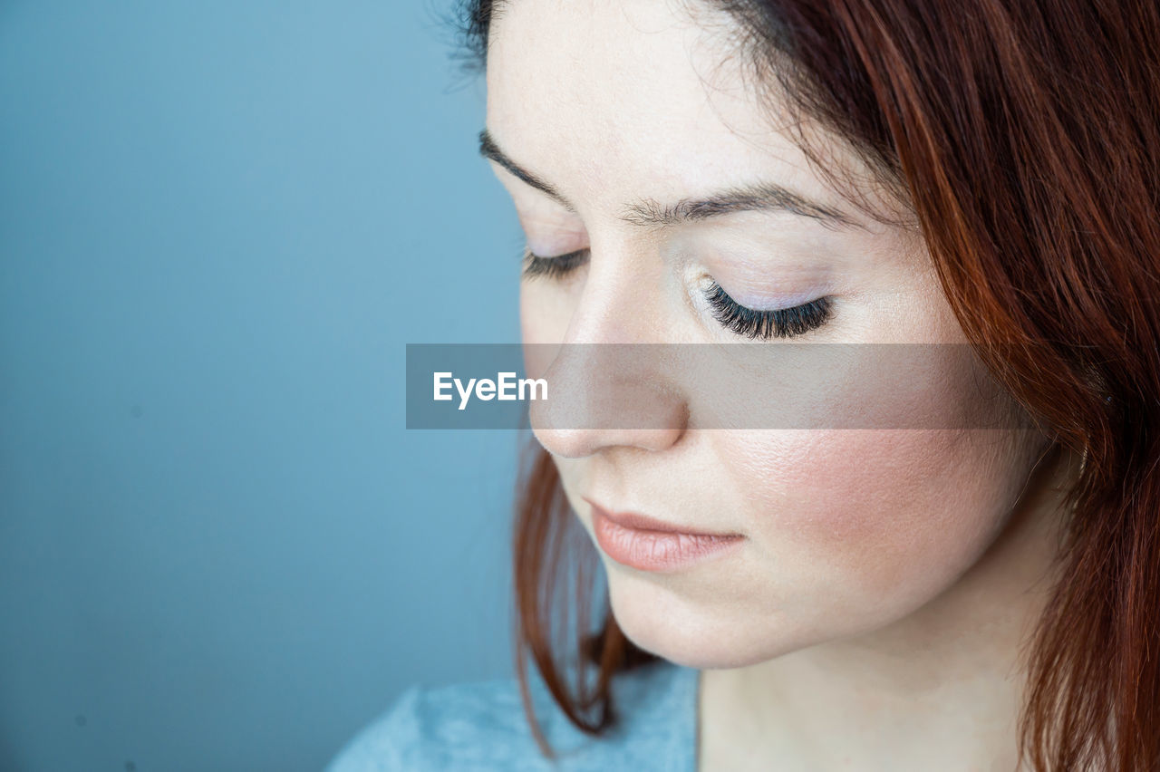Close-up portrait of young woman looking away