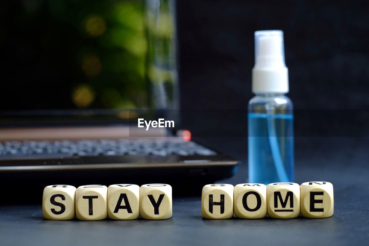 CLOSE-UP OF TEXT ON TABLE AT HOME