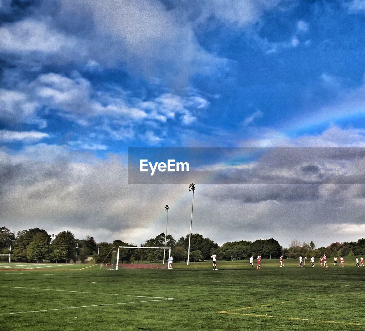 VIEW OF SOCCER FIELD AGAINST CLOUDY SKY