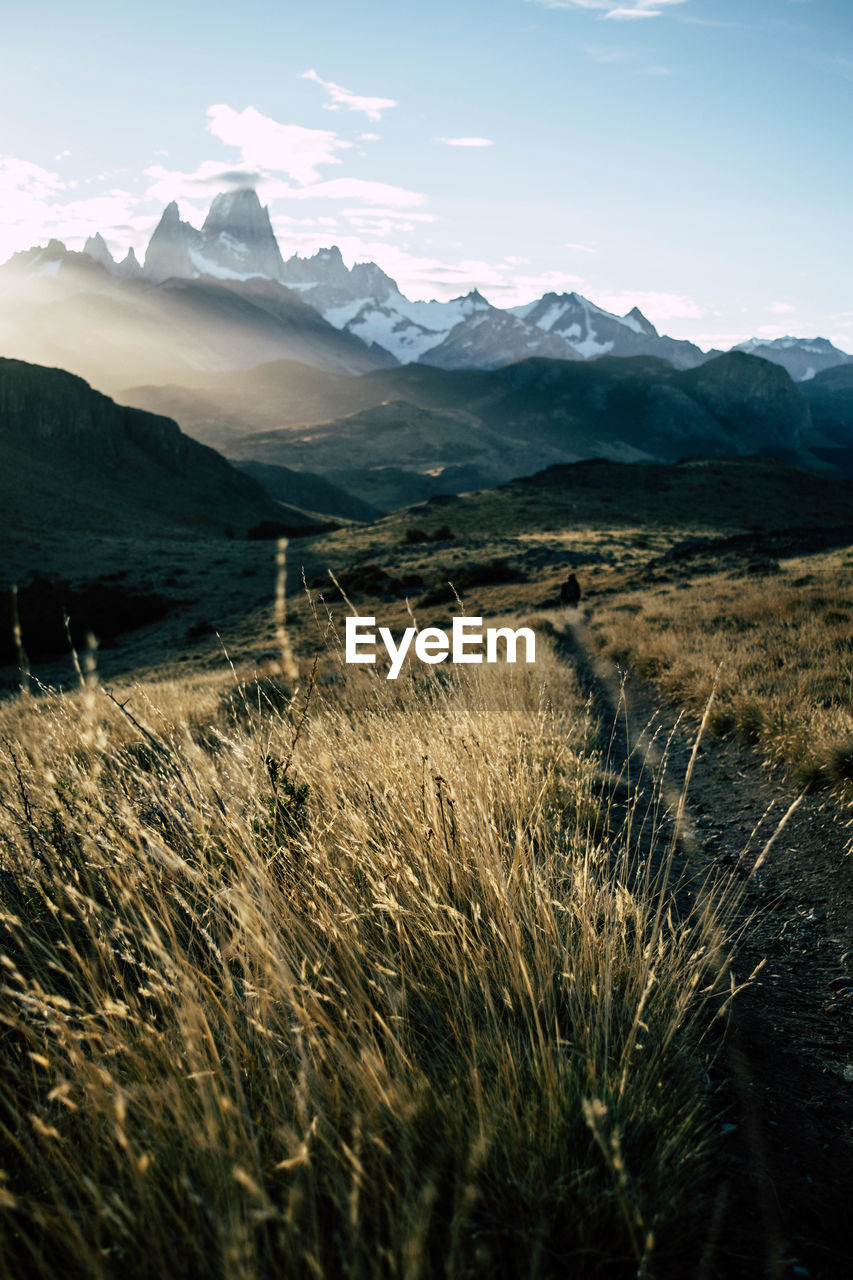 Scenic view of snowcapped mountain peak against sunset sky