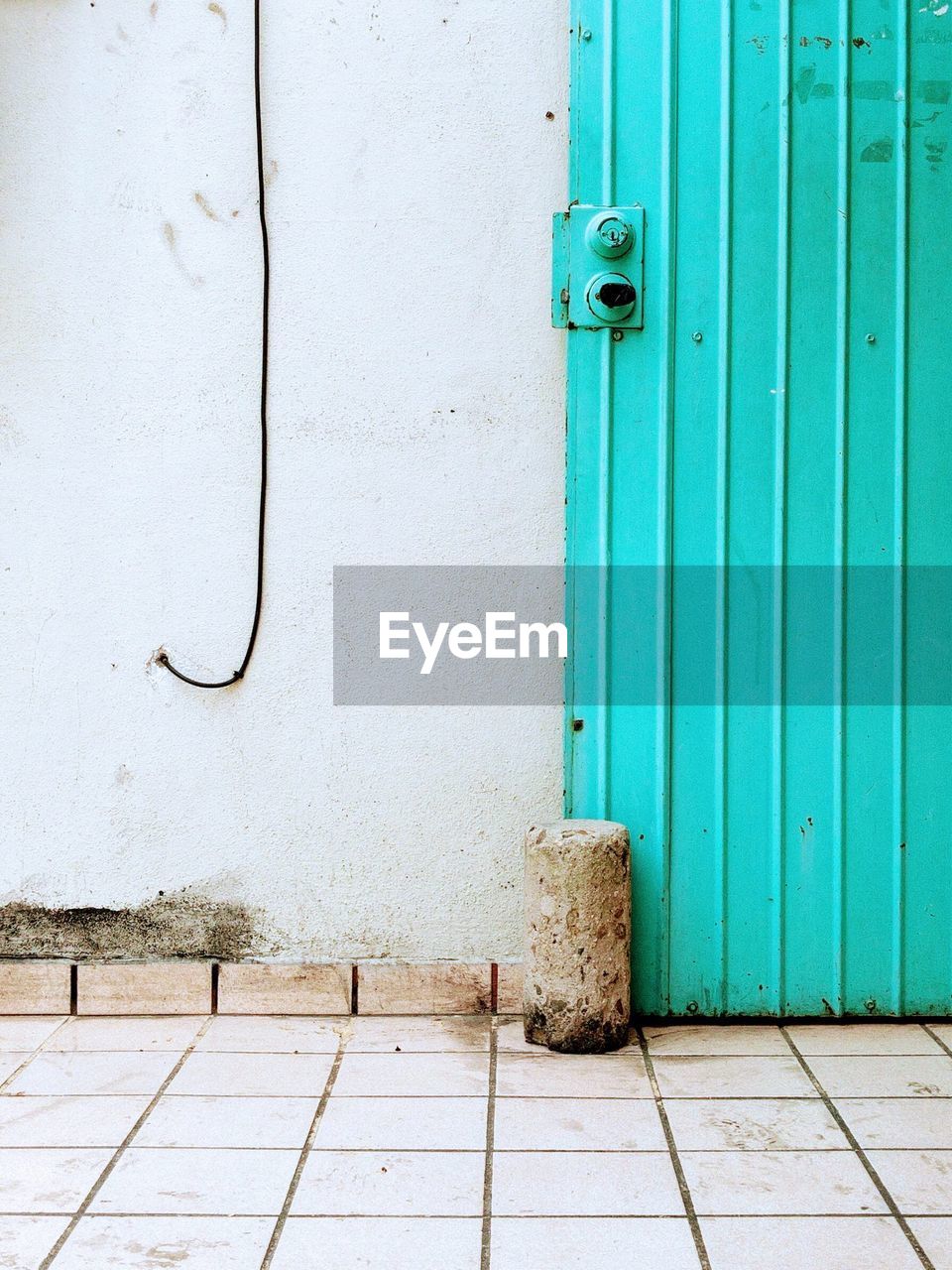 CLOSED DOOR OF WEATHERED BUILDING