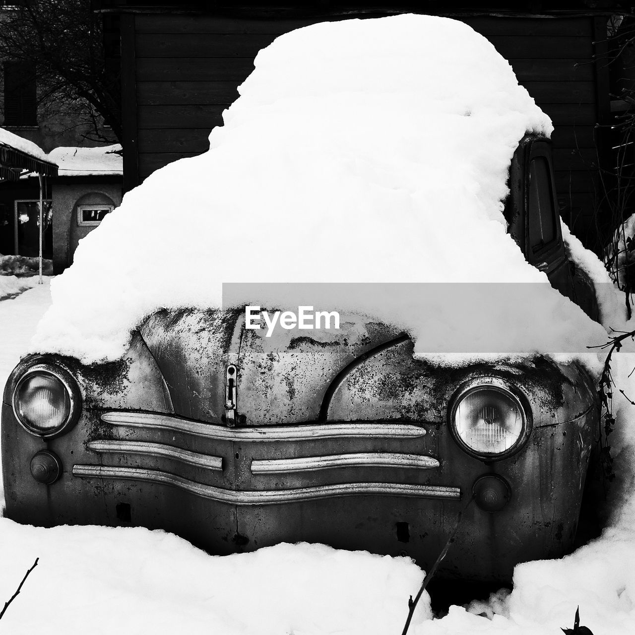 Vintage car covered with snow