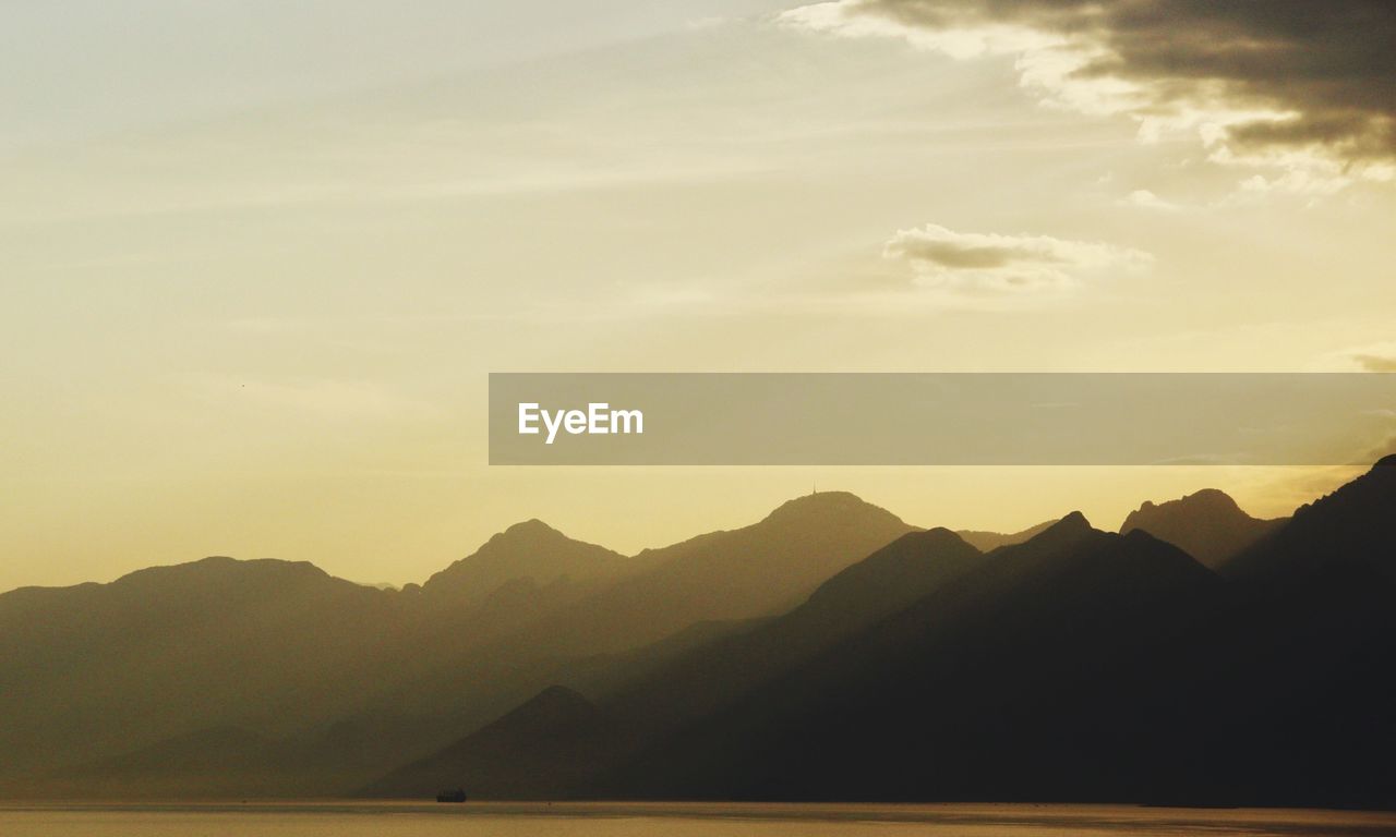 Scenic view of silhouette mountains against sky