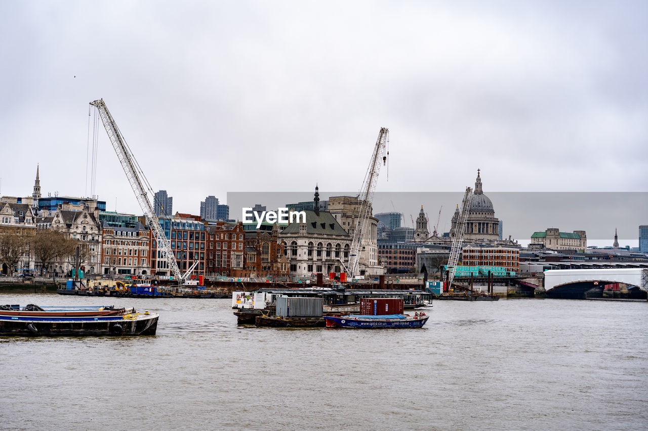 architecture, water, transportation, harbor, built structure, city, nautical vessel, building exterior, sky, travel destinations, vehicle, river, mode of transportation, boat, ship, travel, port, nature, building, cloud, tourism, landscape, waterway, cityscape, bridge, watercraft, craft, overcast, waterfront, urban skyline, no people, the past, history, dock, outdoors, business finance and industry, city life, tower, environment, ferry, day, industry