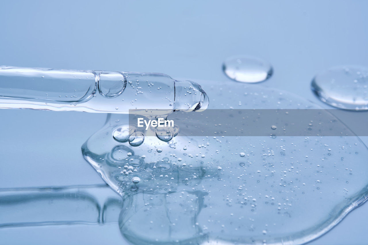 water, drop, blue, studio shot, nature, no people, wet, close-up, bubble, colored background, splashing, motion, purity, indoors, freshness, food and drink, freezing, blue background, transparent, refreshment, simplicity, drinking water, falling, drink, environment, cold drink, cold temperature, backgrounds, shape, macro, azure, glass, splashing droplet, geometric shape, macro photography