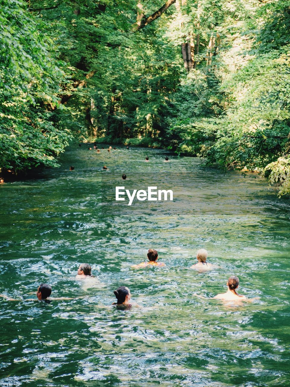 High angle view of people swimming in eisbach river