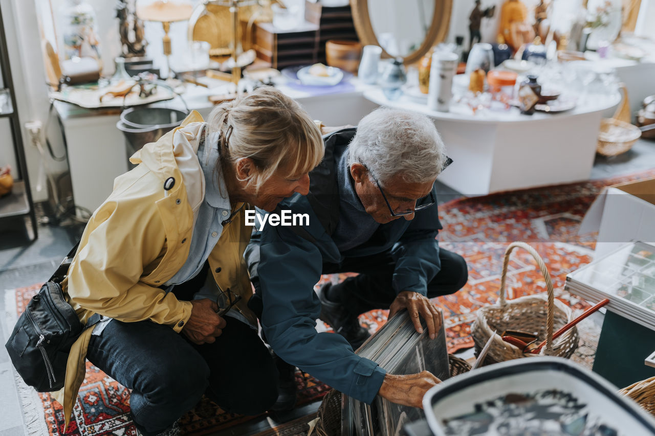 Heterosexual couple examining picture frames in antique shop