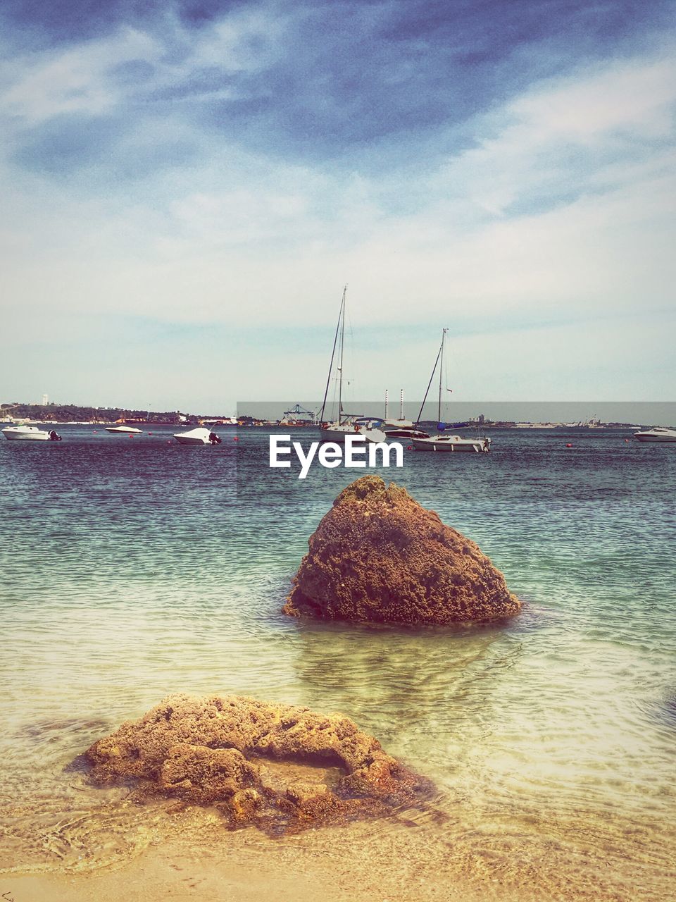 Boats moored on sea against sky