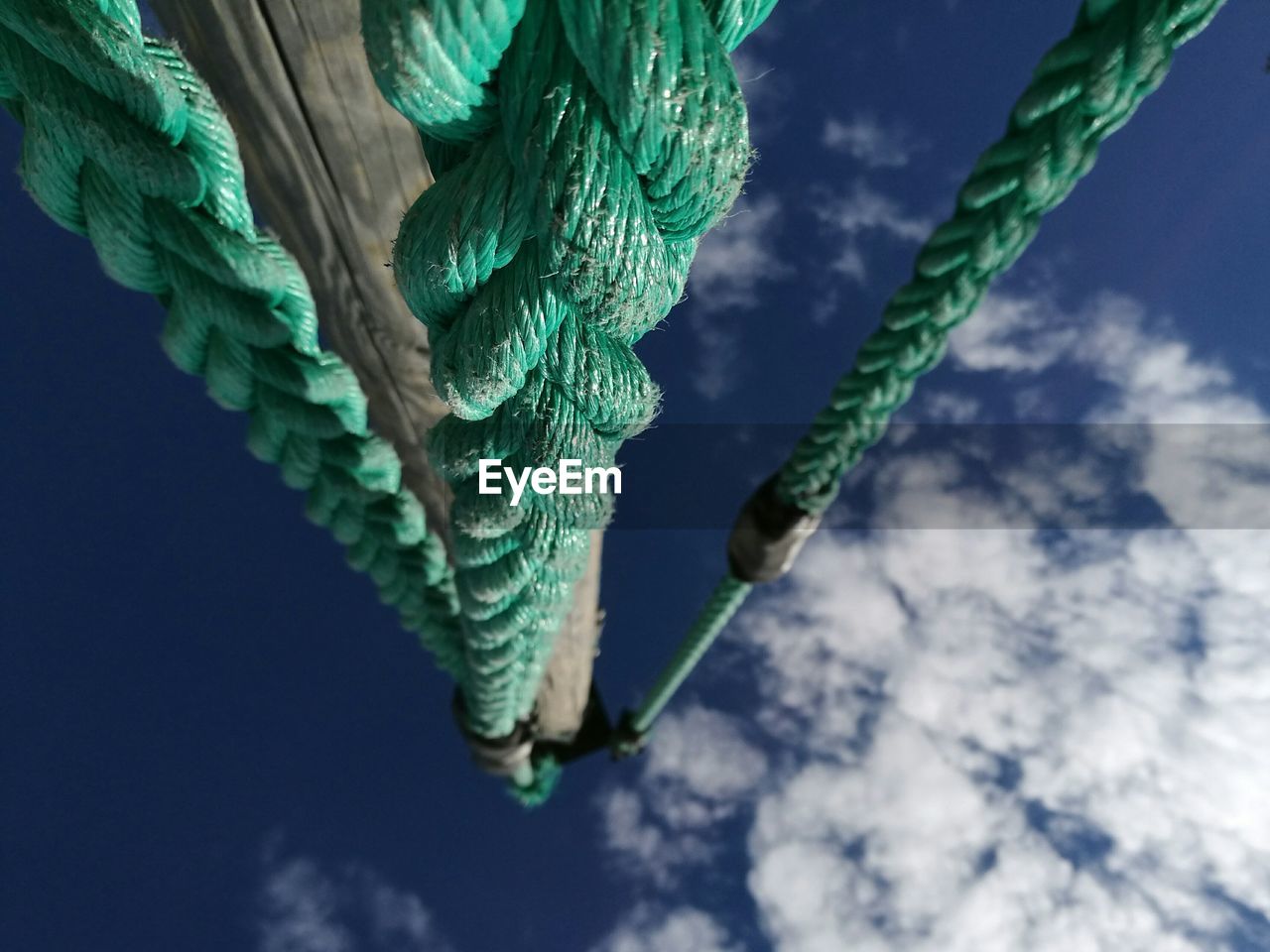 CLOSE-UP OF ROPES AGAINST SKY