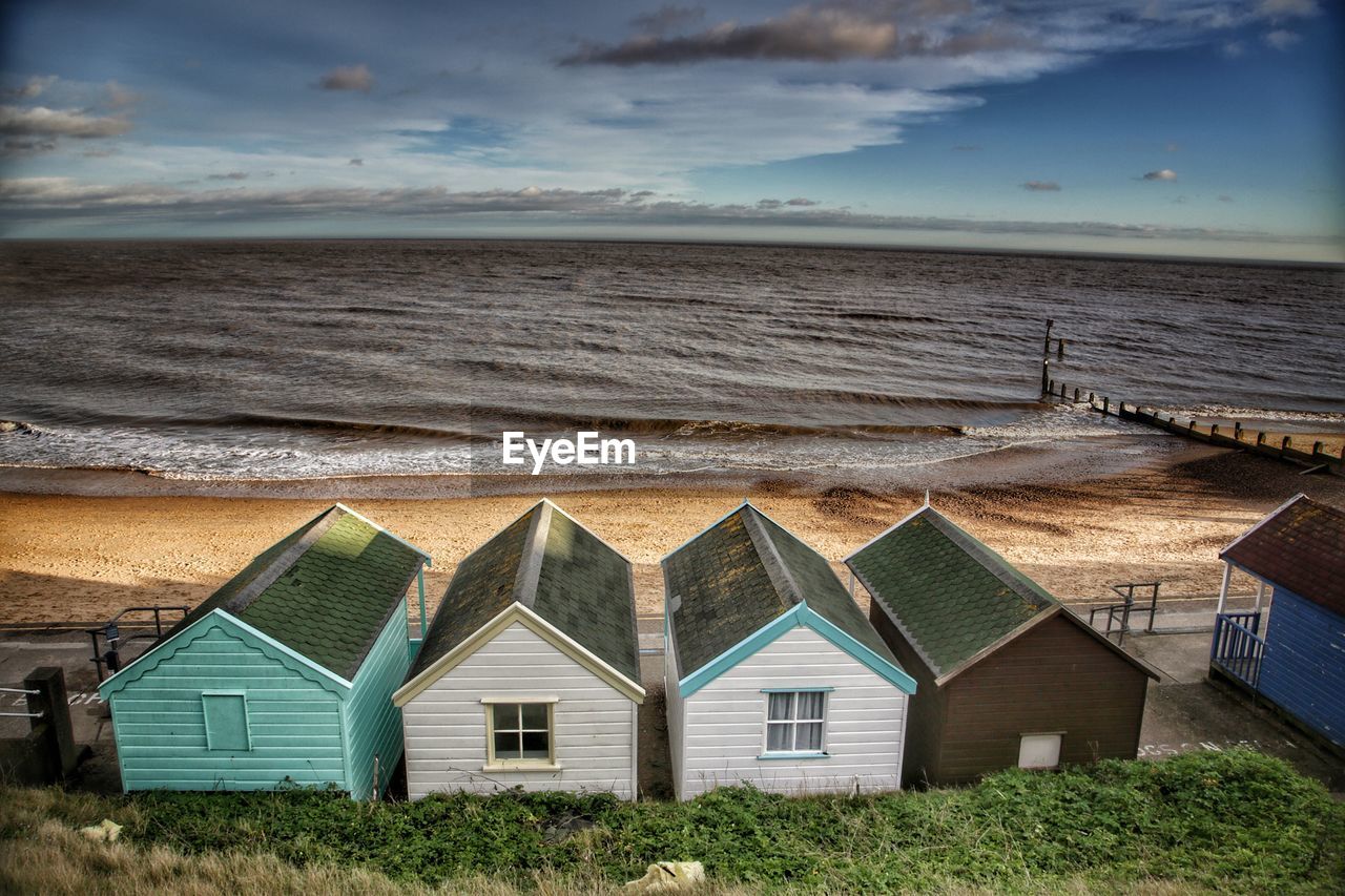 Houses on beach against sky