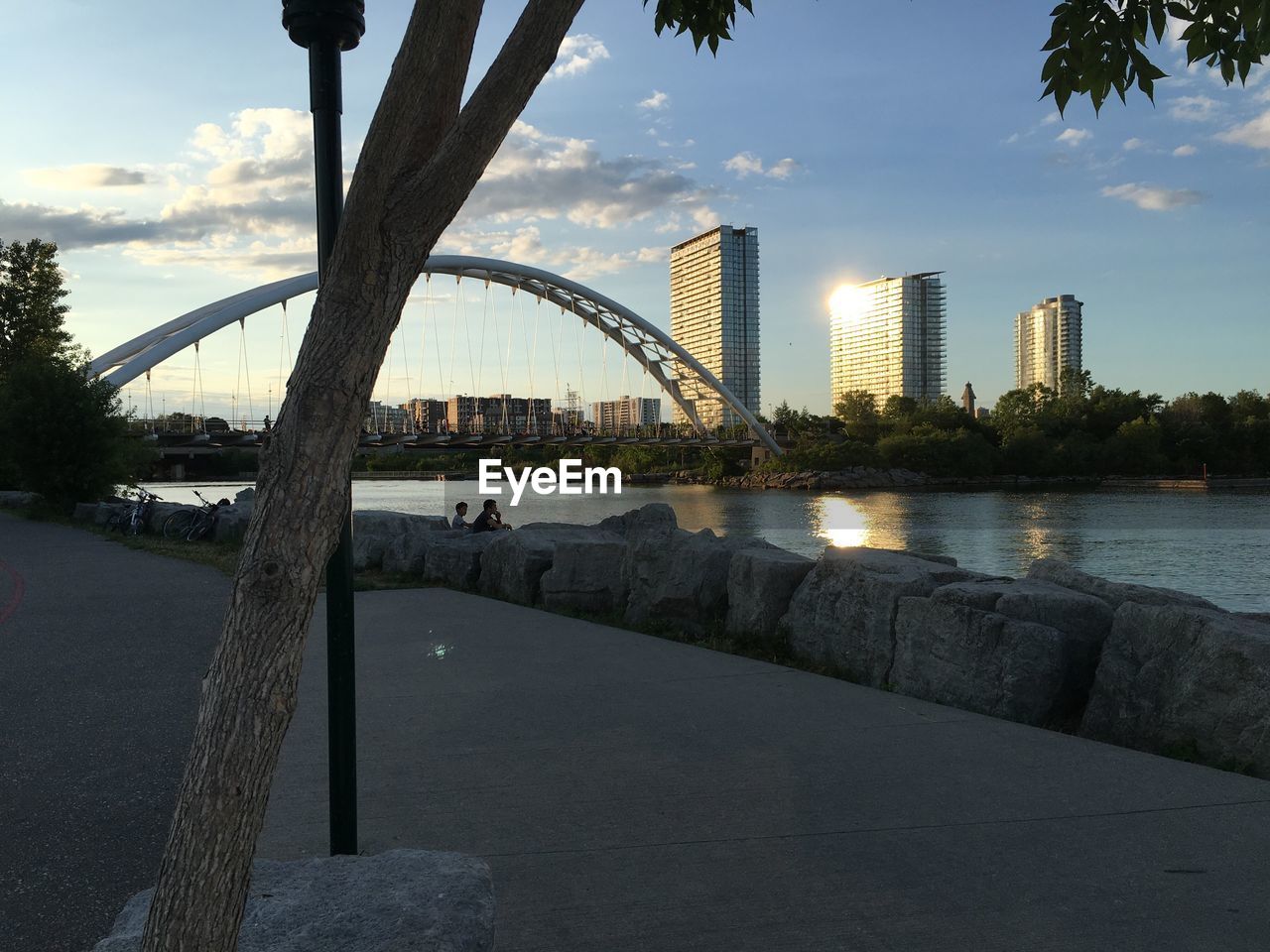 BRIDGE OVER RIVER WITH CITY IN BACKGROUND