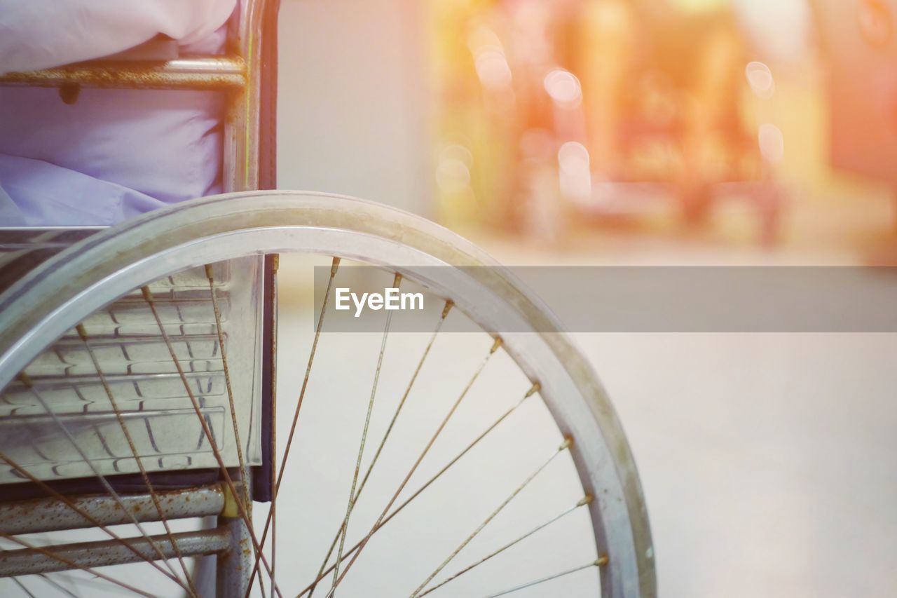 CLOSE-UP OF BICYCLE WHEEL ON STREET