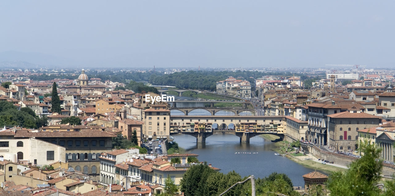 HIGH ANGLE VIEW OF RIVER AND BUILDINGS AGAINST CLEAR SKY