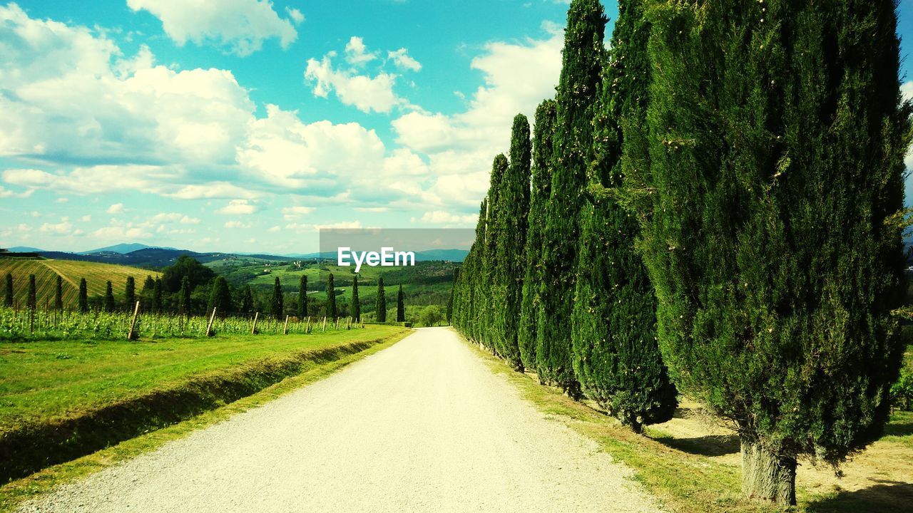 Empty road along countryside landscape