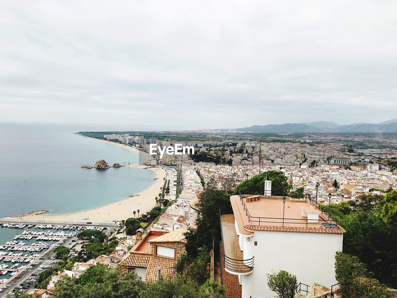 High angle view of townscape by sea against sky