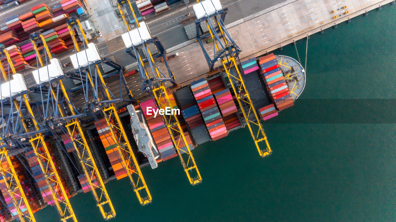 Container ship loading and unloading at deep sea port, aerial view  global business logistic import