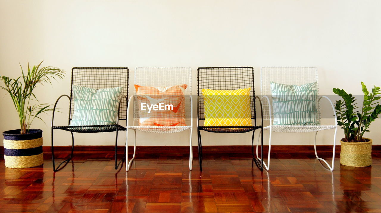 Empty chairs and table against wall at home