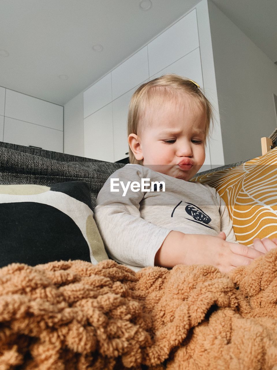 childhood, child, one person, baby, toddler, indoors, blond hair, domestic room, home interior, innocence, furniture, cute, lifestyles, men, person, domestic life, skin, looking, relaxation, toy, portrait, bed, lying down, emotion, bedroom, baby clothing, babyhood, living room