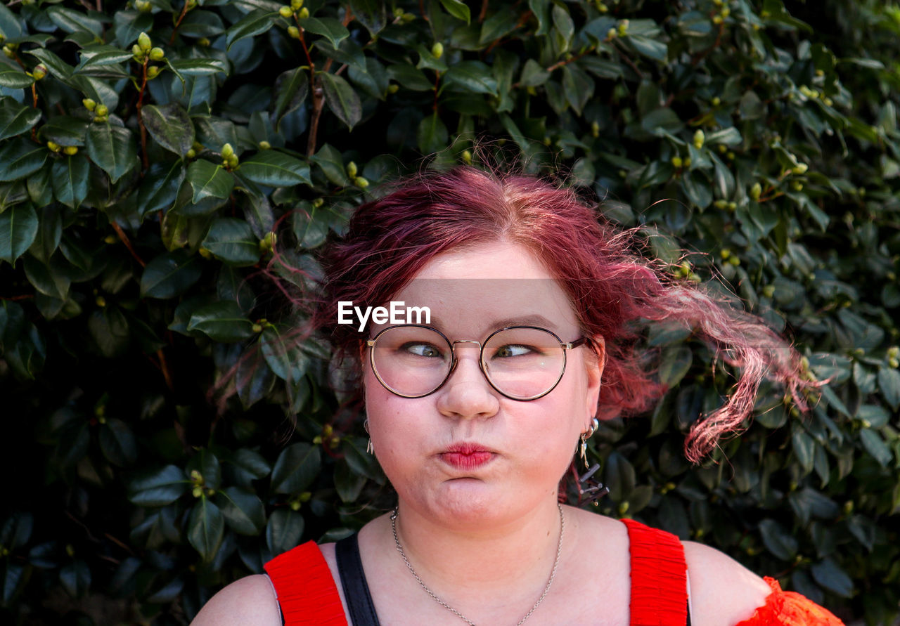 PORTRAIT OF A YOUNG WOMAN WITH EYEGLASSES