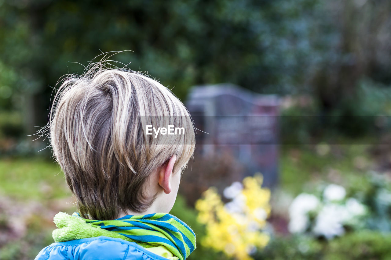 Close-up of boy in graveyard