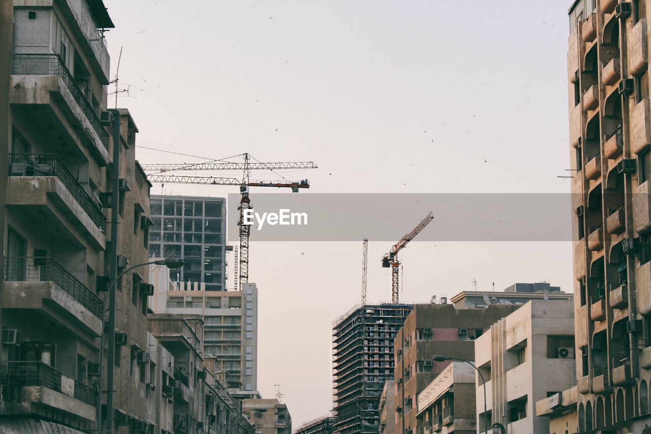 LOW ANGLE VIEW OF RESIDENTIAL BUILDINGS AGAINST CLEAR SKY