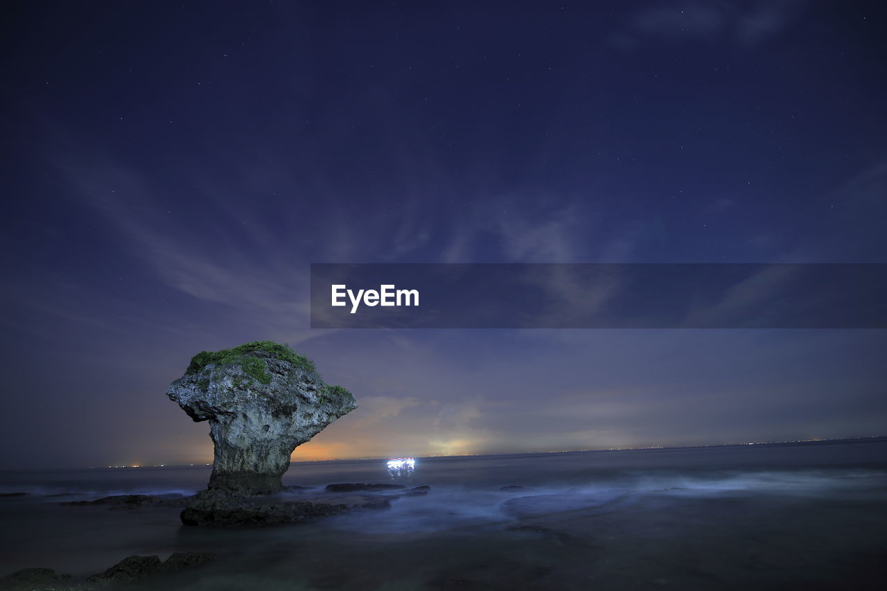 SCENIC VIEW OF BEACH AGAINST SKY AT NIGHT