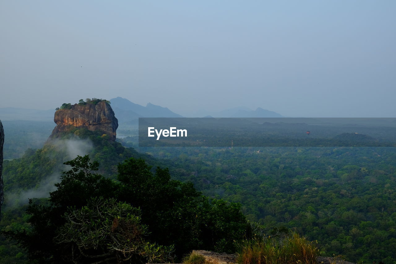 environment, scenics - nature, tree, sky, landscape, nature, land, hill, plant, beauty in nature, fog, wilderness, travel, travel destinations, forest, no people, tranquility, outdoors, tourism, morning, rock, terrain, non-urban scene, tranquil scene, ridge, mountain range, cliff, natural environment, architecture, jungle, sea, blue