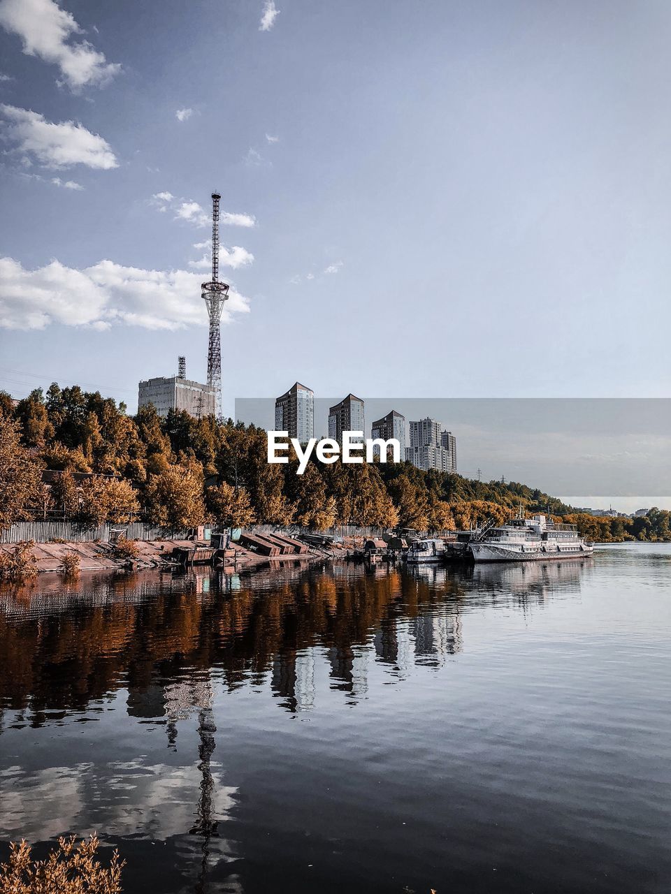 BUILDINGS BY RIVER AGAINST SKY