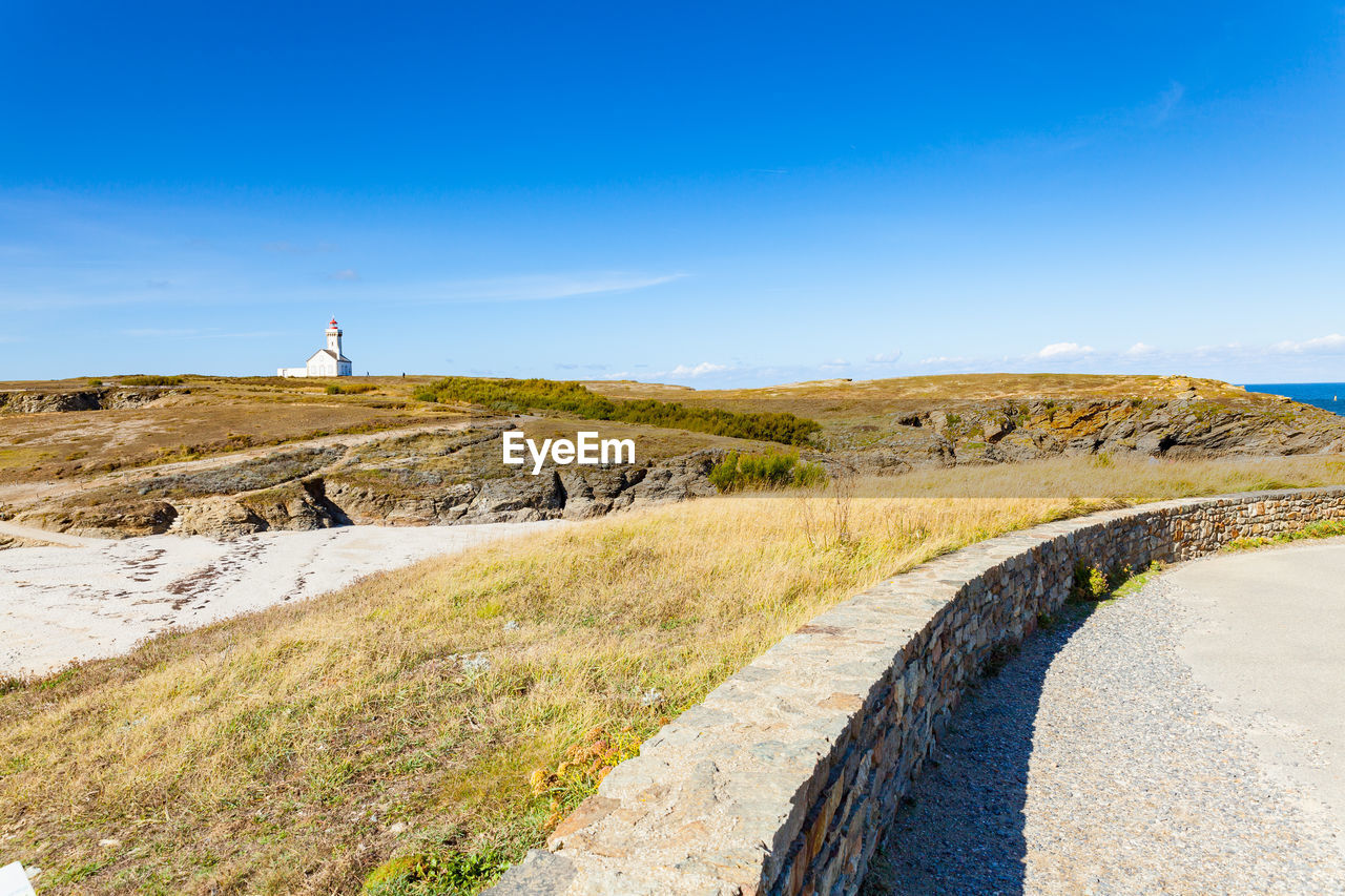 Scenic view of land against blue sky